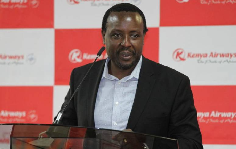 An image of Kenya Airways CEO Allan Kilavuka speaking at a past event