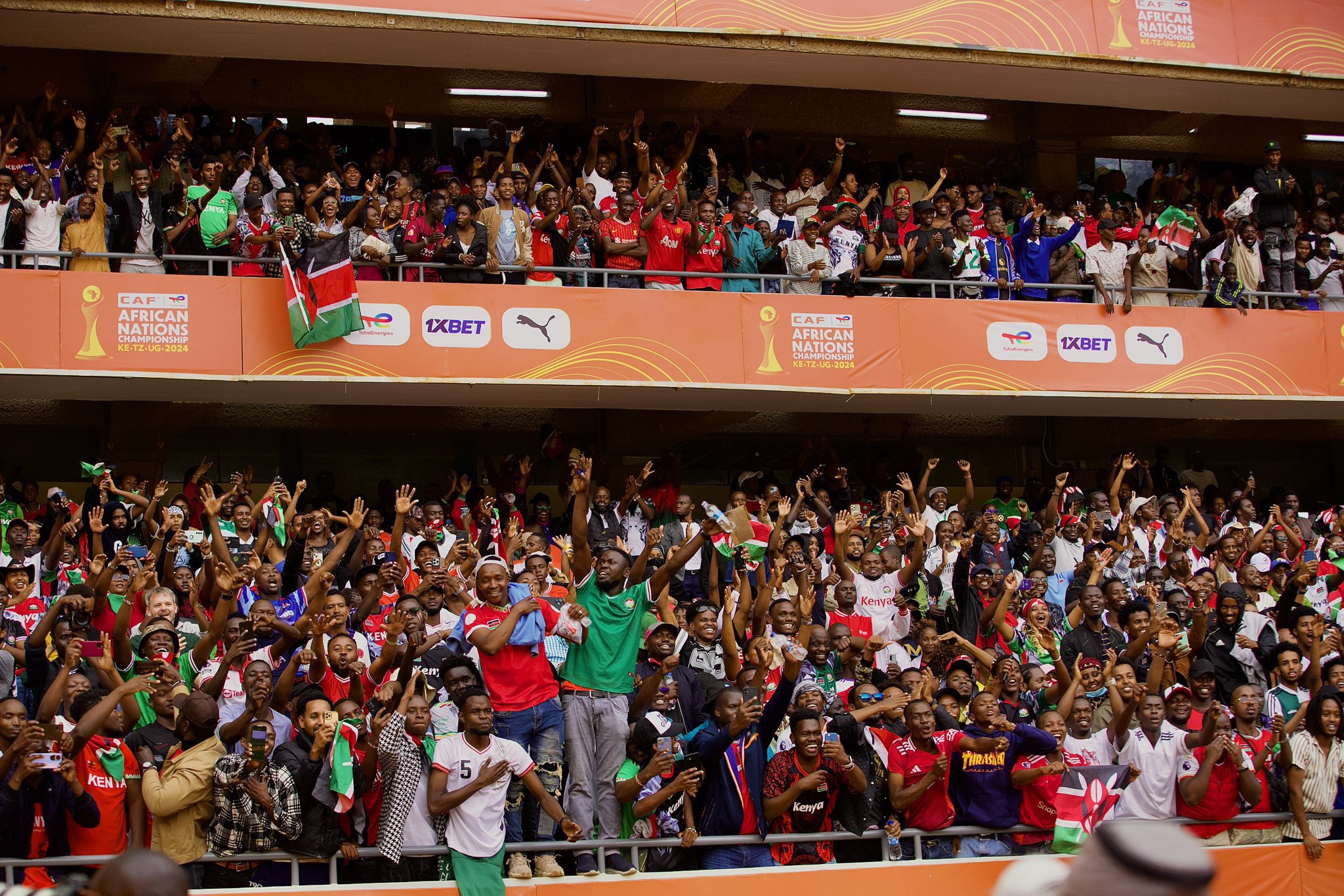 An image of Kenyan fans cheering for the Harambee stars against Morocco during CHAN games at Kasarani stadium.