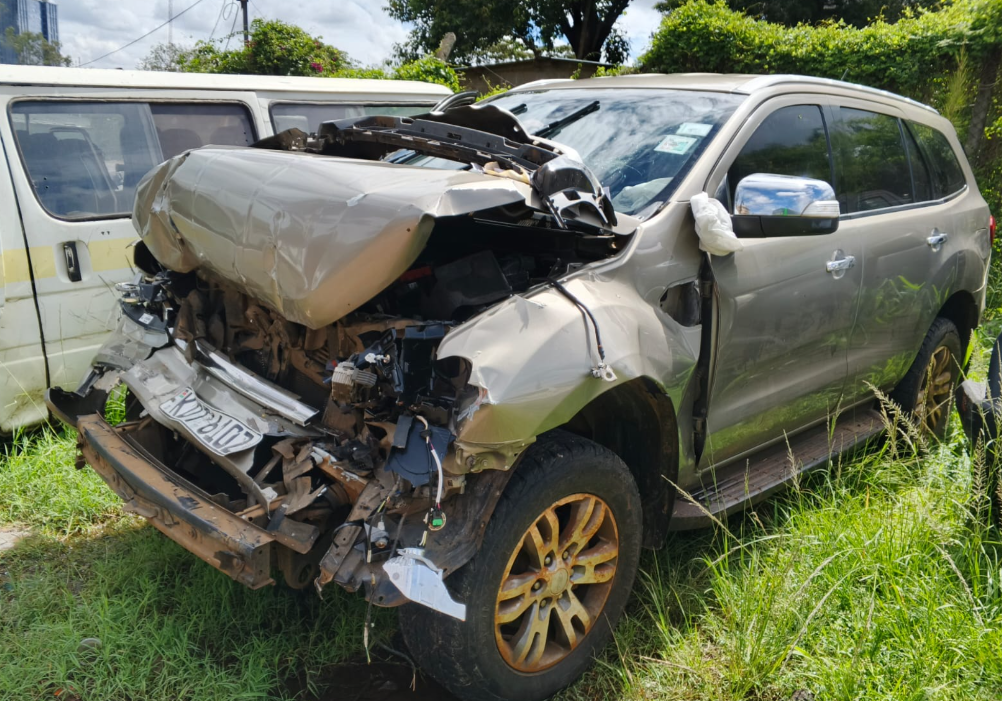 Official Veterinary Medicines Directorate (VMD) Ford Everest vehicle (registration KDT 610Z) shown damaged after a road crash, with visible impact on the front section including a crushed bonnet, deployed airbag, and broken headlights.